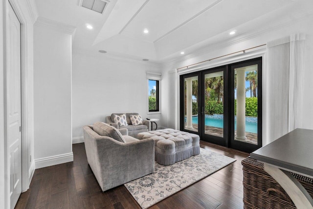 living room featuring a tray ceiling, dark hardwood / wood-style flooring, french doors, and ornamental molding