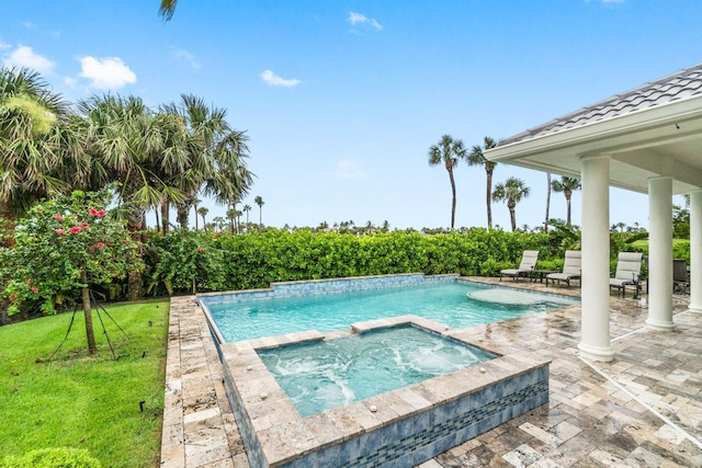 view of swimming pool featuring an in ground hot tub, a yard, and a patio area