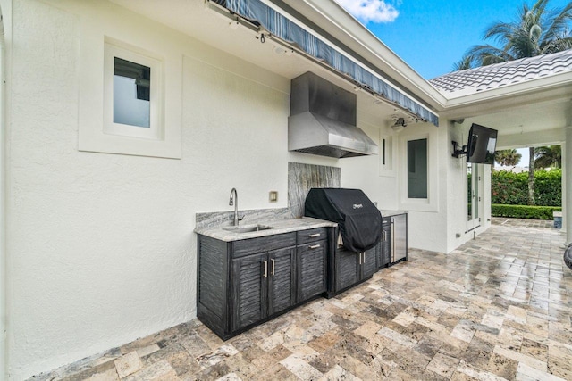 view of patio / terrace featuring area for grilling, exterior kitchen, and sink