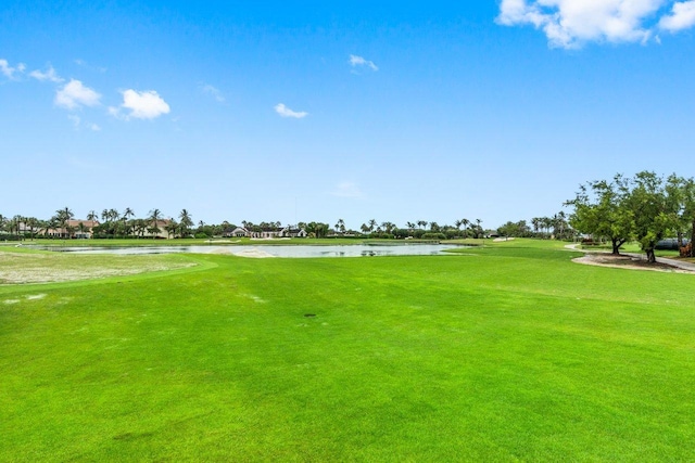 surrounding community featuring a yard and a water view