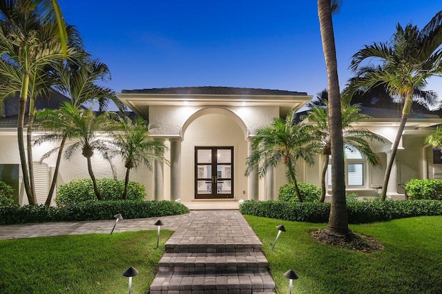 doorway to property with french doors and a yard