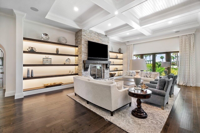 living room with dark hardwood / wood-style flooring, a fireplace, ornamental molding, coffered ceiling, and beamed ceiling