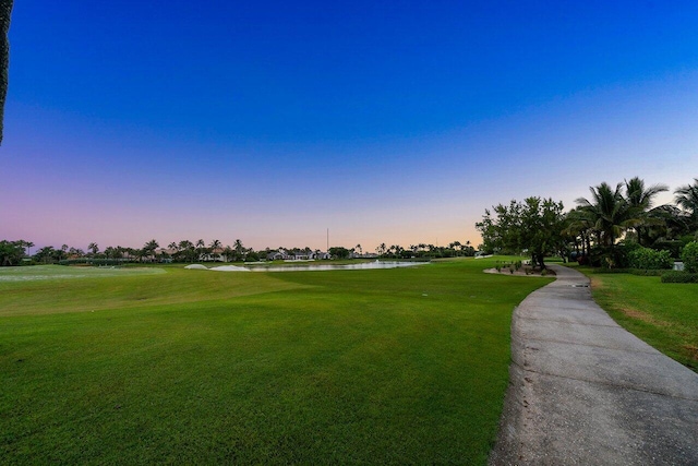 view of property's community featuring a yard and a water view