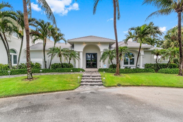 mediterranean / spanish house with a front lawn