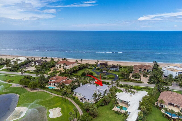 bird's eye view featuring a water view and a beach view