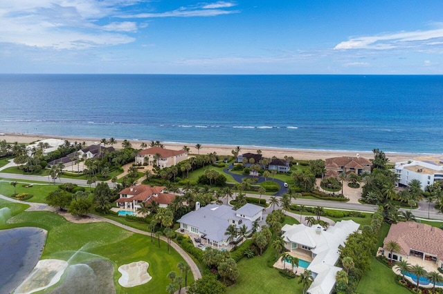 drone / aerial view featuring a water view and a beach view