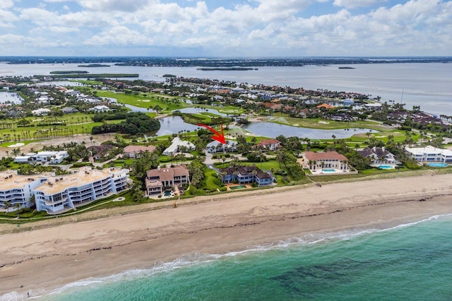 drone / aerial view featuring a water view and a beach view