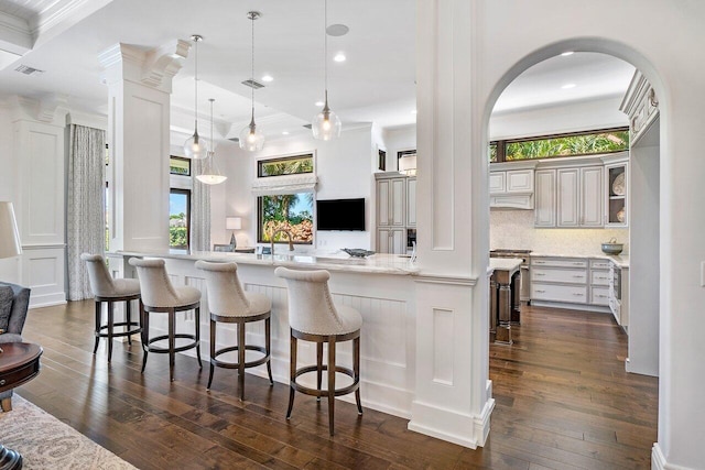 kitchen featuring kitchen peninsula, a kitchen breakfast bar, dark hardwood / wood-style flooring, backsplash, and decorative light fixtures