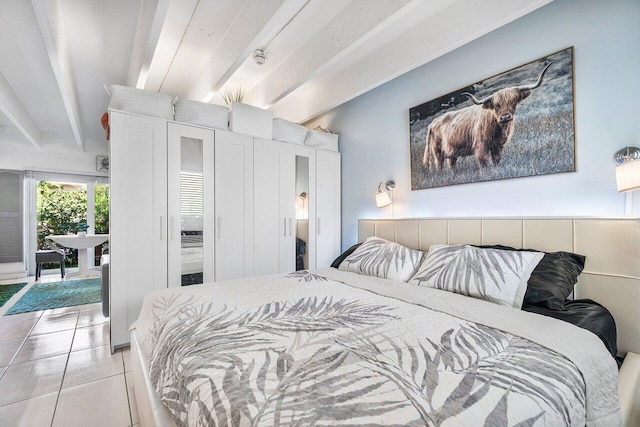 bedroom featuring beam ceiling and light tile patterned floors