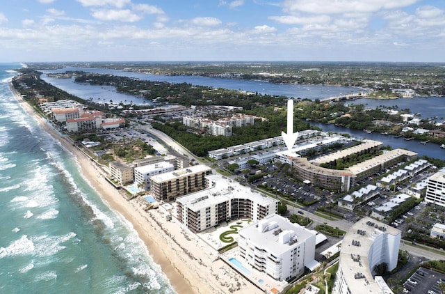 drone / aerial view featuring a water view and a beach view