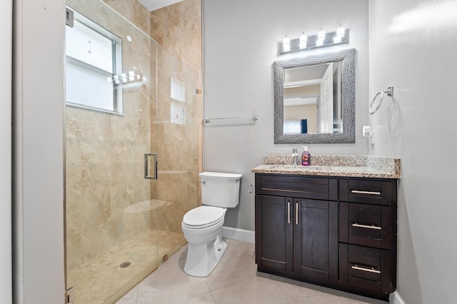 bathroom with tile patterned flooring, toilet, vanity, and walk in shower