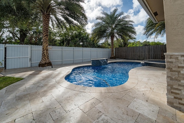 view of swimming pool with a patio area, an in ground hot tub, and pool water feature