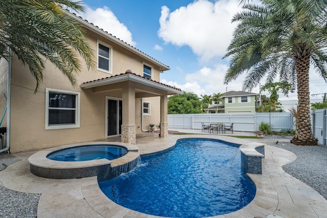 view of pool with pool water feature, a patio area, and an in ground hot tub