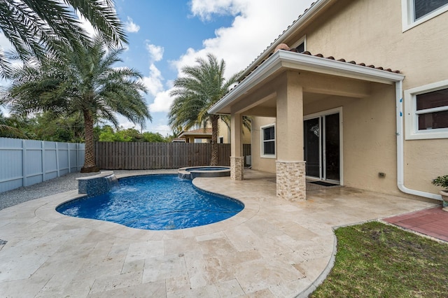 view of swimming pool featuring an in ground hot tub and a patio