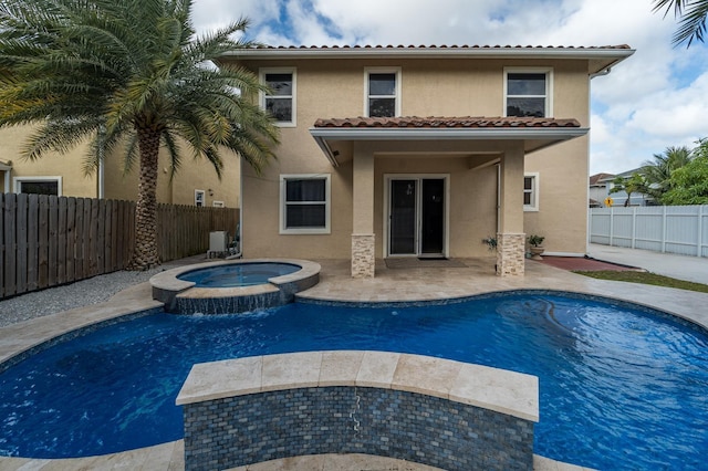 view of pool with an in ground hot tub and a patio