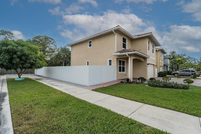 view of property exterior with a yard and a garage