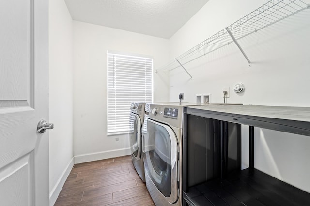 washroom featuring independent washer and dryer, a textured ceiling, and dark wood-type flooring