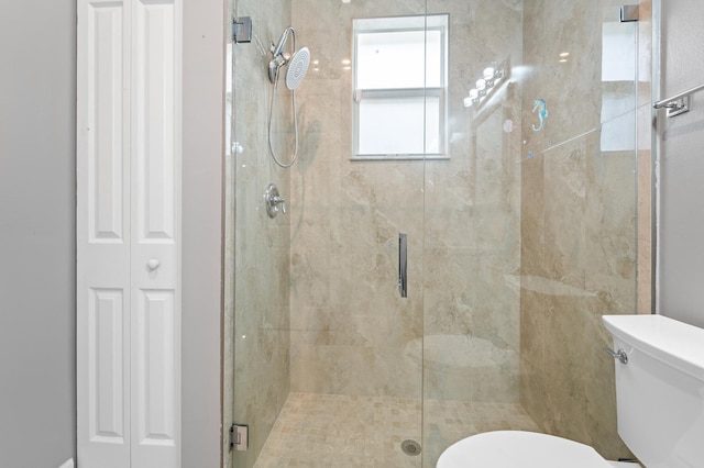 bathroom featuring toilet and walk in shower