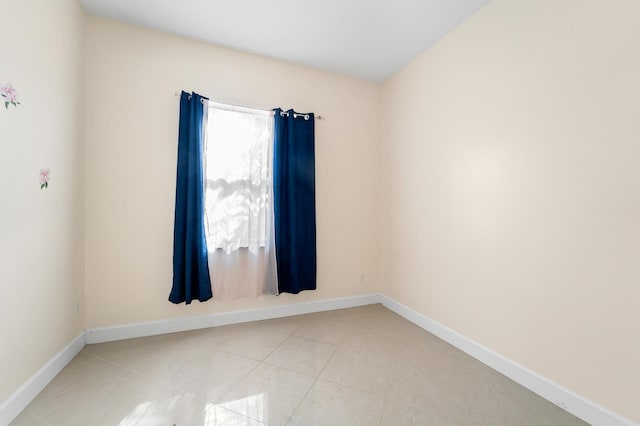 spare room with light tile patterned floors