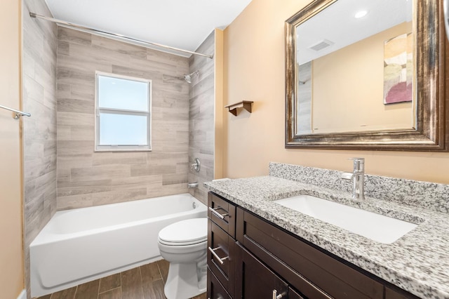 full bathroom with vanity, toilet, and tiled shower / bath