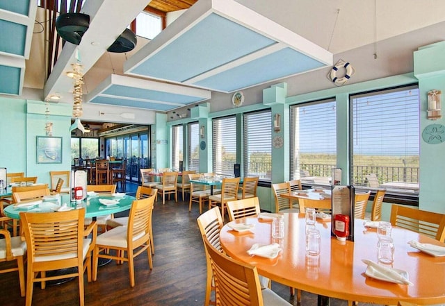 dining space with dark hardwood / wood-style flooring