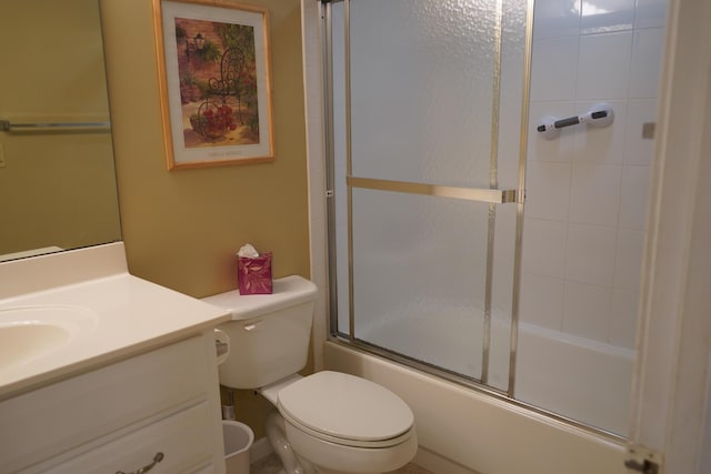 full bathroom with vanity, enclosed tub / shower combo, and toilet