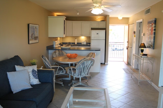 2400 S Ocean Dr Unit 1224, Fort Pierce, FL 34949 - kitchen featuring freestanding refrigerator, a peninsula, a sink, dark countertops, and a ceiling fan