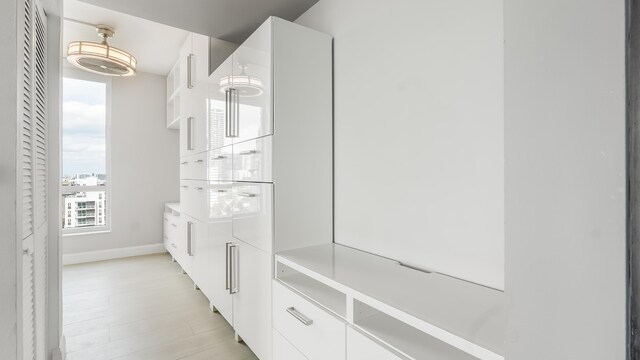 kitchen featuring stainless steel dishwasher, pendant lighting, dark brown cabinetry, and sink