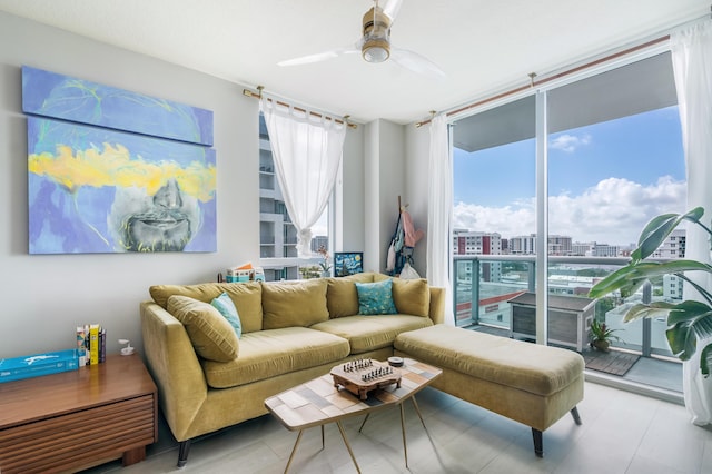 living room with a wall of windows and ceiling fan