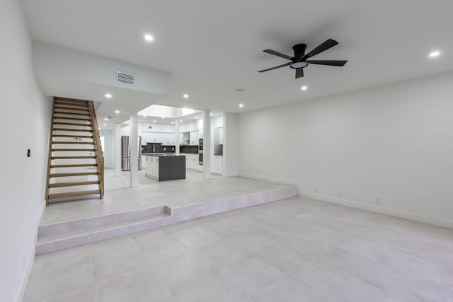 unfurnished living room featuring ceiling fan