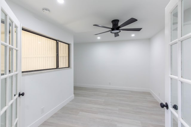 spare room featuring ceiling fan, light hardwood / wood-style floors, and french doors