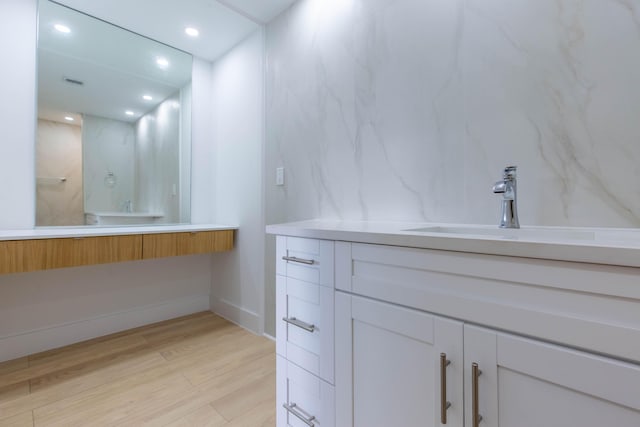 bathroom with hardwood / wood-style flooring and sink