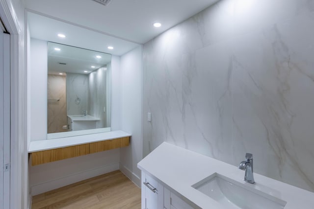 bathroom with hardwood / wood-style floors and vanity