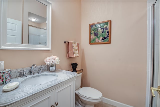 bathroom with a shower with door, vanity, and toilet