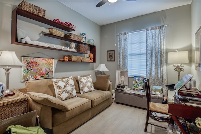 living room with light hardwood / wood-style flooring, a wealth of natural light, and ceiling fan