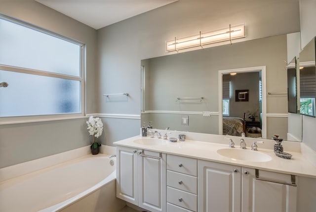 bathroom with a bath and vanity