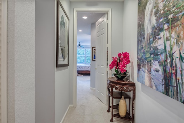 hallway with light colored carpet