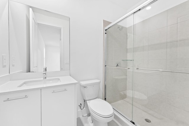 bathroom featuring vanity, toilet, and walk in shower