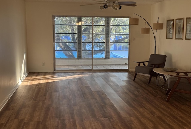 sitting room featuring ceiling fan and dark hardwood / wood-style flooring