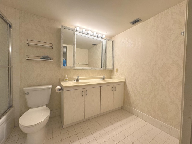 full bathroom featuring tile patterned flooring, vanity, toilet, and bath / shower combo with glass door