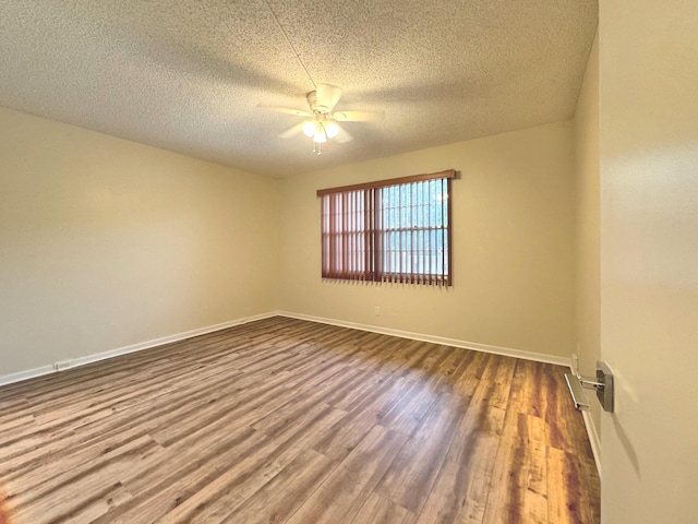 spare room with ceiling fan, hardwood / wood-style floors, and a textured ceiling