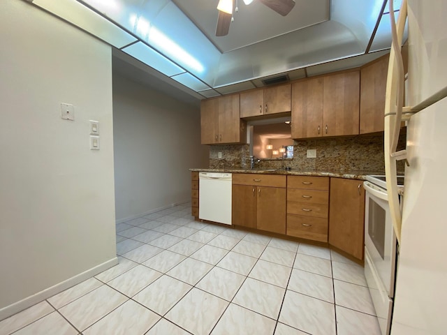 kitchen featuring white appliances, sink, ceiling fan, tasteful backsplash, and stone countertops