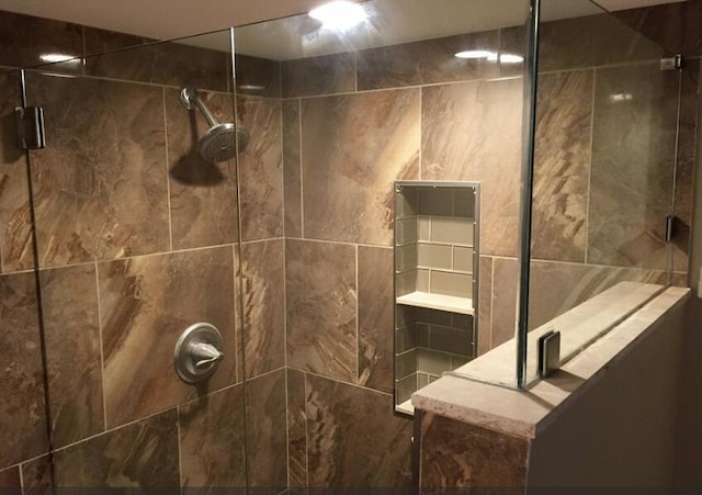 bathroom with a shower with shower door