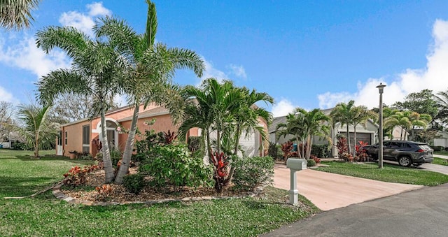 view of front of home featuring a garage and a front lawn