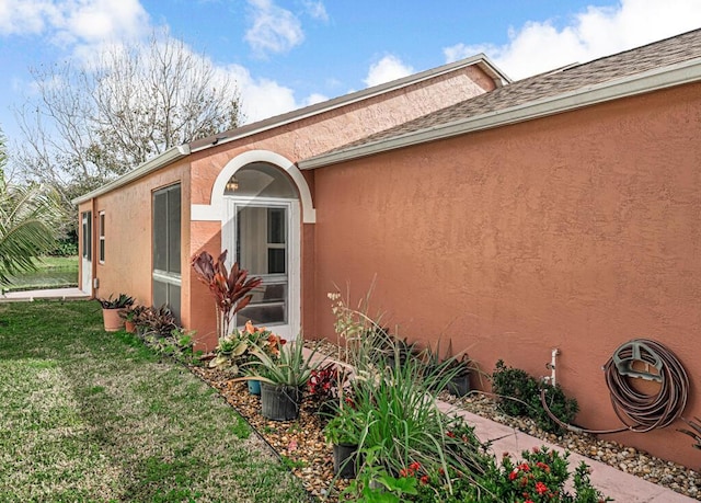 view of side of property with a lawn