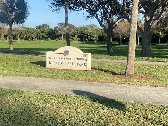 view of property's community with a lawn