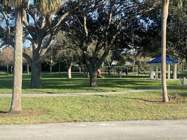 view of home's community with a lawn and a playground