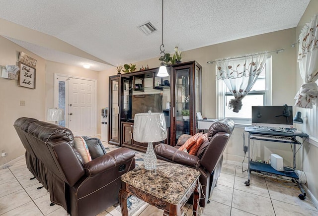 living room featuring light tile patterned floors, vaulted ceiling, and a textured ceiling