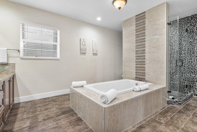 bathroom featuring vanity, plus walk in shower, and hardwood / wood-style flooring