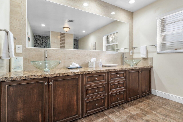 bathroom featuring backsplash, walk in shower, vanity, and hardwood / wood-style flooring